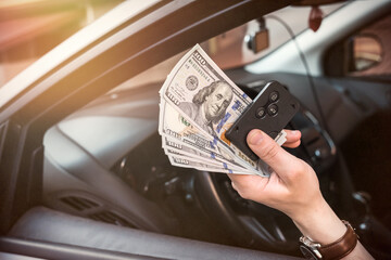 man rent car for trip and holding dolar and auto key