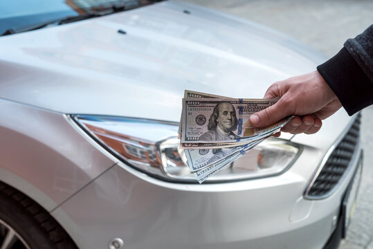 purchase new acr concept. man holding dollar for rent auto