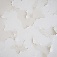 Close-up picture of an old grange white concrete wall with crumbling plaster for background or texture