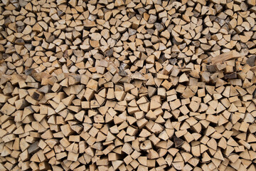 Composition pile of wood logs for background. Natural wooden logs stacked Stocking up for winter. A pile of cut tree brown trunks