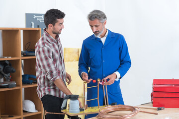 tradesman training apprentice to weld copper pipe