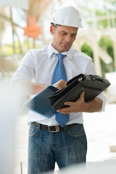 representative salesman on site closing his satchel