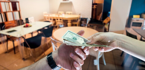 customer buys new furniture in the store, gives dollars to the seller