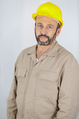 male builder in hardhat with electric drill smiling portrait