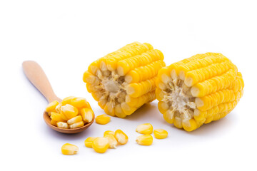 Delicious sweet yellow ripe corn kernels are placed in a wooden spoon and placed on the ground. White background