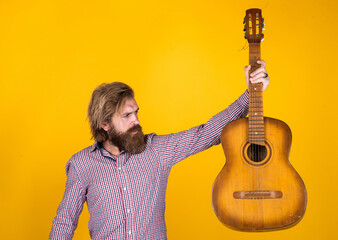 acoustic guitar player. mature hipster musician with beard. brutal caucasian guy playing guitar. country music. bearded man singing song. handsome man singer and guitarist. Fashion portrait of man
