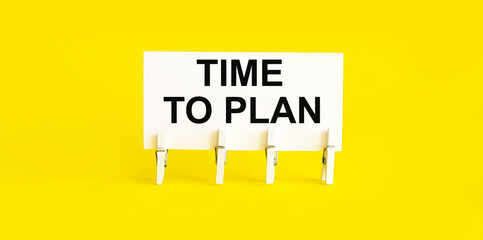 text TIME TO PLAN on white short note paper yellow background