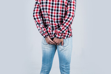 guy in checkered shirt has problems with rectum. male feel pain in anal. casual male need medical...