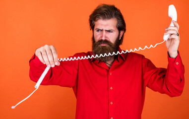 it is broken. brutal man with telephone. communication. bearded man wear red shirt. casual male...