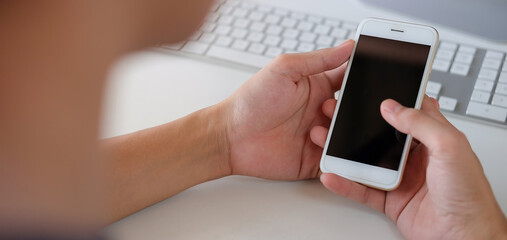 Close up of man using mobile smartphone at home, He searching or social networks.
