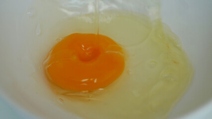 Close Up Image with a Fresh Egg White and Yolk Prepared for Cooking in the Kitchen for Breakfast
