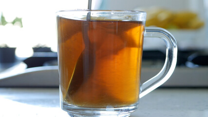 Image with Making a Hot and Aromatic Tea with Sugar and Fresh Lemon Using Natural Tea Leaves