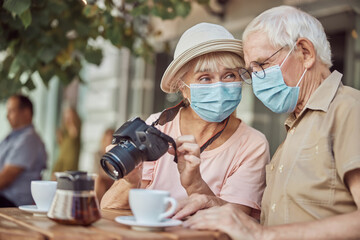 Female photographer gazing at a gray-haired man