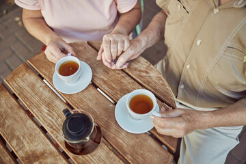Loving elderly couple sitting in a cafe