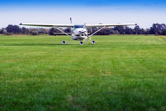 The Plane Is Standing On A Grassy Airport