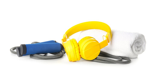 Jumping rope, towel and headphones on white background