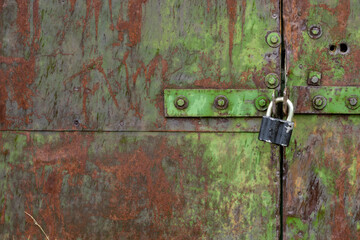Old door with an old lock. Old padlock.