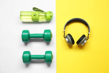 Bottle of water, dumbbells and headphones on color background