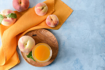 Composition with fresh peach juice on table