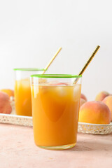 Glasses of fresh peach juice on table