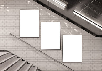 Three vertical billboards on underground stairs wall Mockup. Triptych hoardings advertising in white tiles tunnel interior. 3D rendering