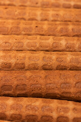 Golden, brown, twisted homemade Russian waffles, waffle texture, vertical format