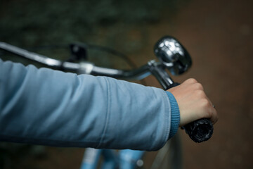 Woman's hand on the handlebars of a bicycle