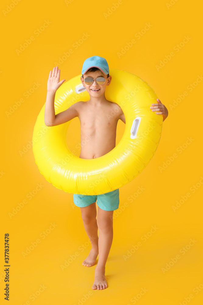 Poster little boy with swimming ring on color background