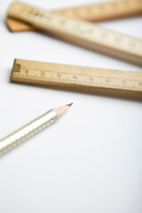 pencil and close up of folding ruler