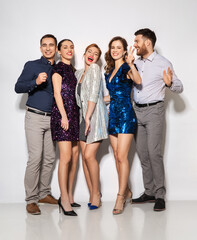 celebration, people and holiday style concept - happy friends in party clothes over white background