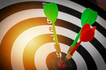 Success hitting target goal achievement  three darts arrows in the target center business goal