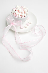 marshmallows in coffee cup with pink ribbon