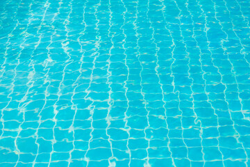 Reflections from the water in the blue swimming pool