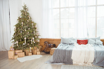 Stylish room interior with beautiful Christmas tree and gift boxes