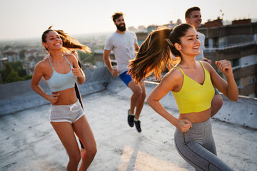 Group of happy fit people friends exercising together outdoor