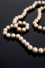 pearl necklace on black background