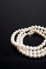 pearl necklace on black background