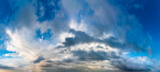 Fantastic clouds against blue sky, panorama