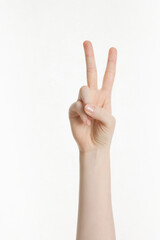 woman's hand making peace sign on white background