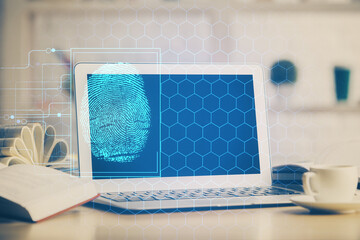 Computer on desktop in office with finger print drawing. Double exposure. Concept of business data security.
