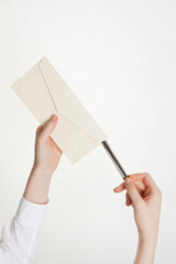 woman opening envelope with paper knife on white background