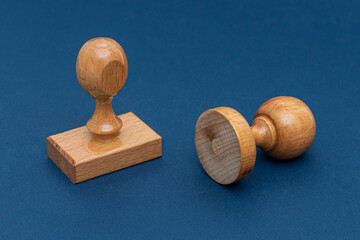 Wooden rubber stamps isolated on blue background.