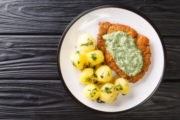 Delicious German food schnitzel with boiled new potatoes and the famous Frankfurt green sauce...