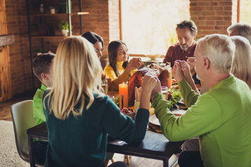Photo of full family prayer time hold hands thanks giving dinner event homemade feast sit served...