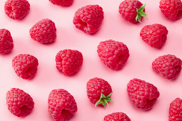 ripe raspberries on pink background. top view. flat lay