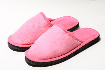Pink female slippers on a white background