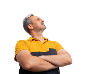 Man with arms crossed looking up at blank copyspace for text