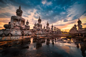 Tuinposter Many Statue buddha image at sunset in southen of Thailand © nuttawutnuy