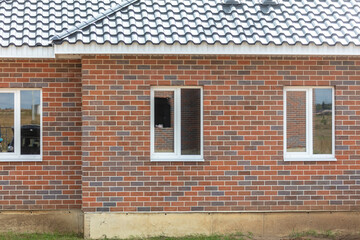 Windows to a new brick cottage in the village
