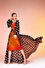 Glamour fashion woman long brunette hair natural evening makeup wear sexy silk long dress polka dot...